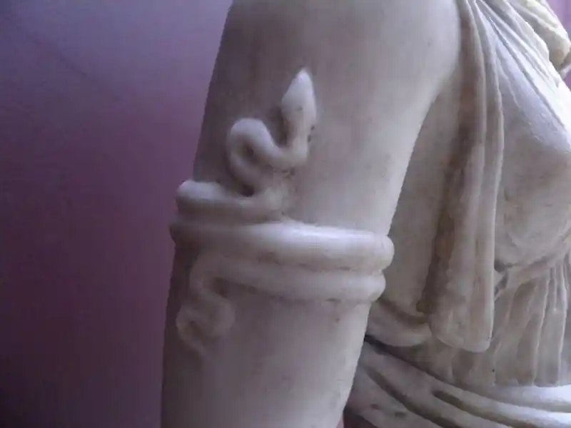 Snake on the arm of Artemis. Statue of Artemis